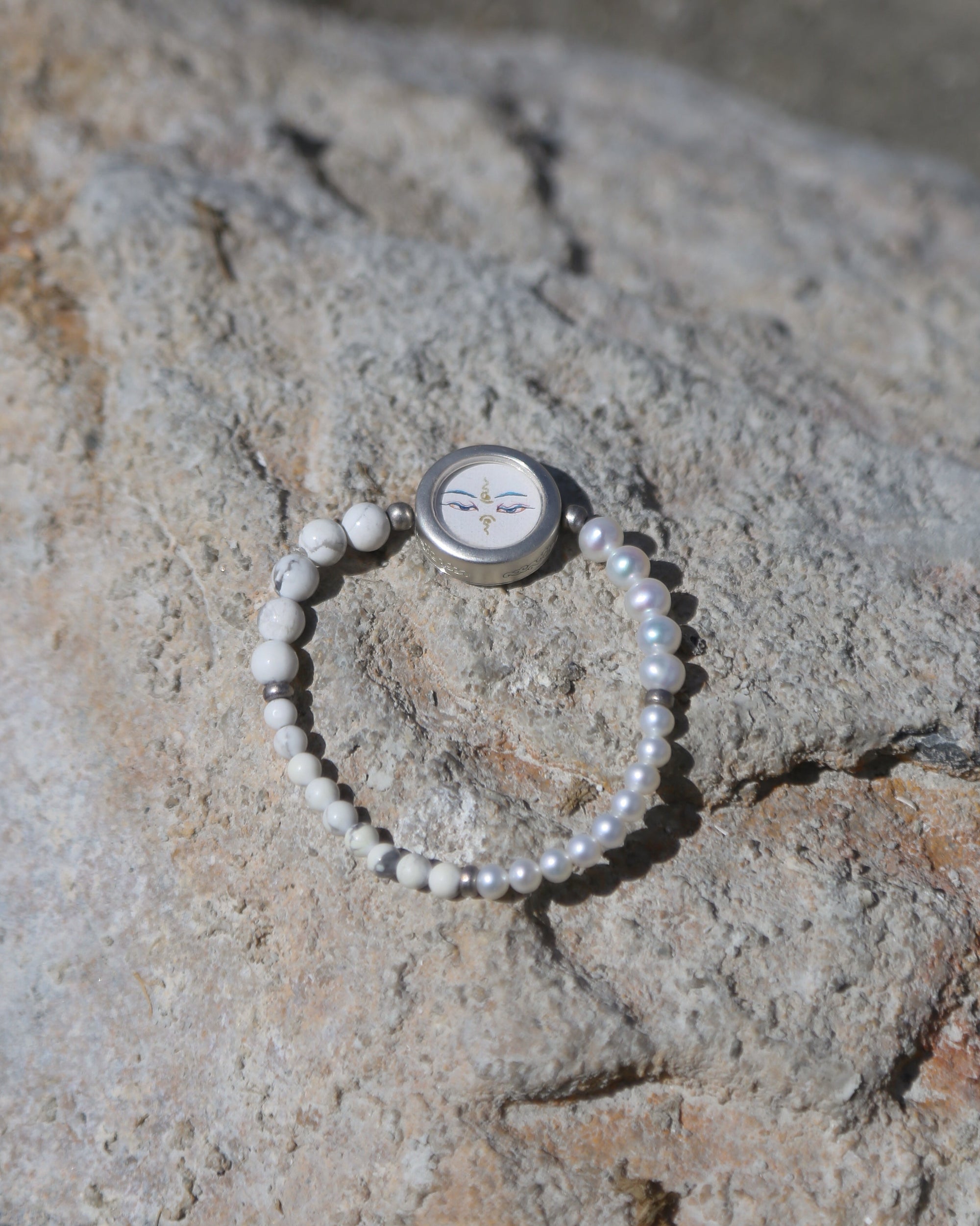 Pearl bracelet on a textured stone surface